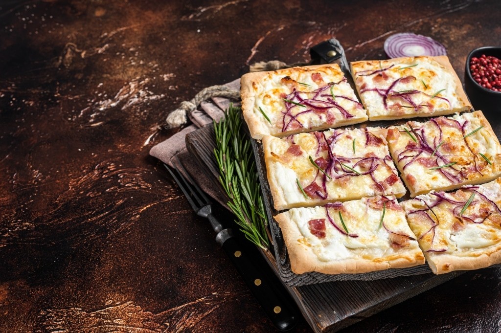 French tarte flambee with cream cheese, bacon and onions. Flammk